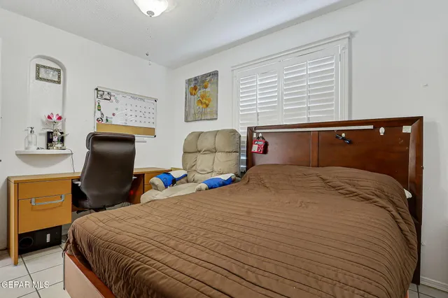 a view of an empty room with wooden floor and cabinet
