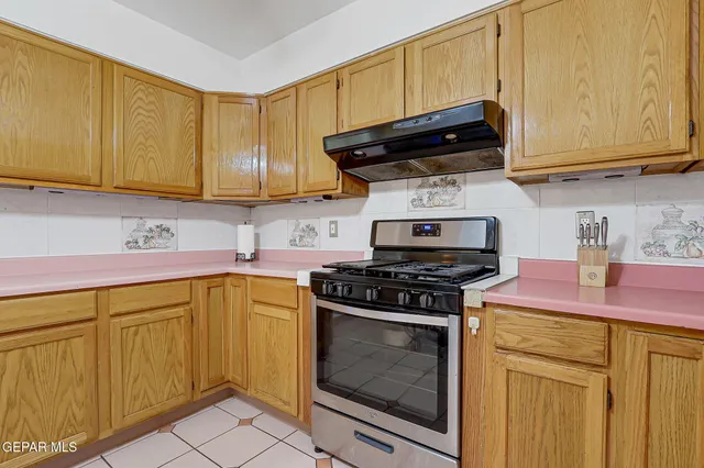 a kitchen with granite countertop cabinets and steel stainless steel appliances