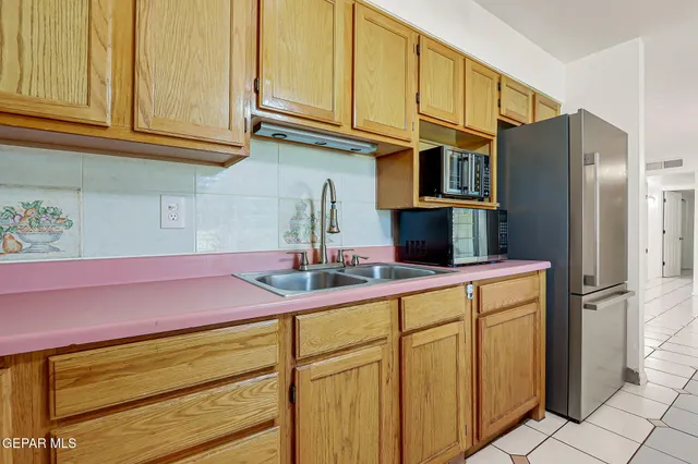 a kitchen with stainless steel appliances granite countertop a refrigerator and cabinets