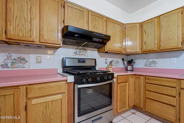 a kitchen with stainless steel appliances granite countertop a stove a microwave and cabinets