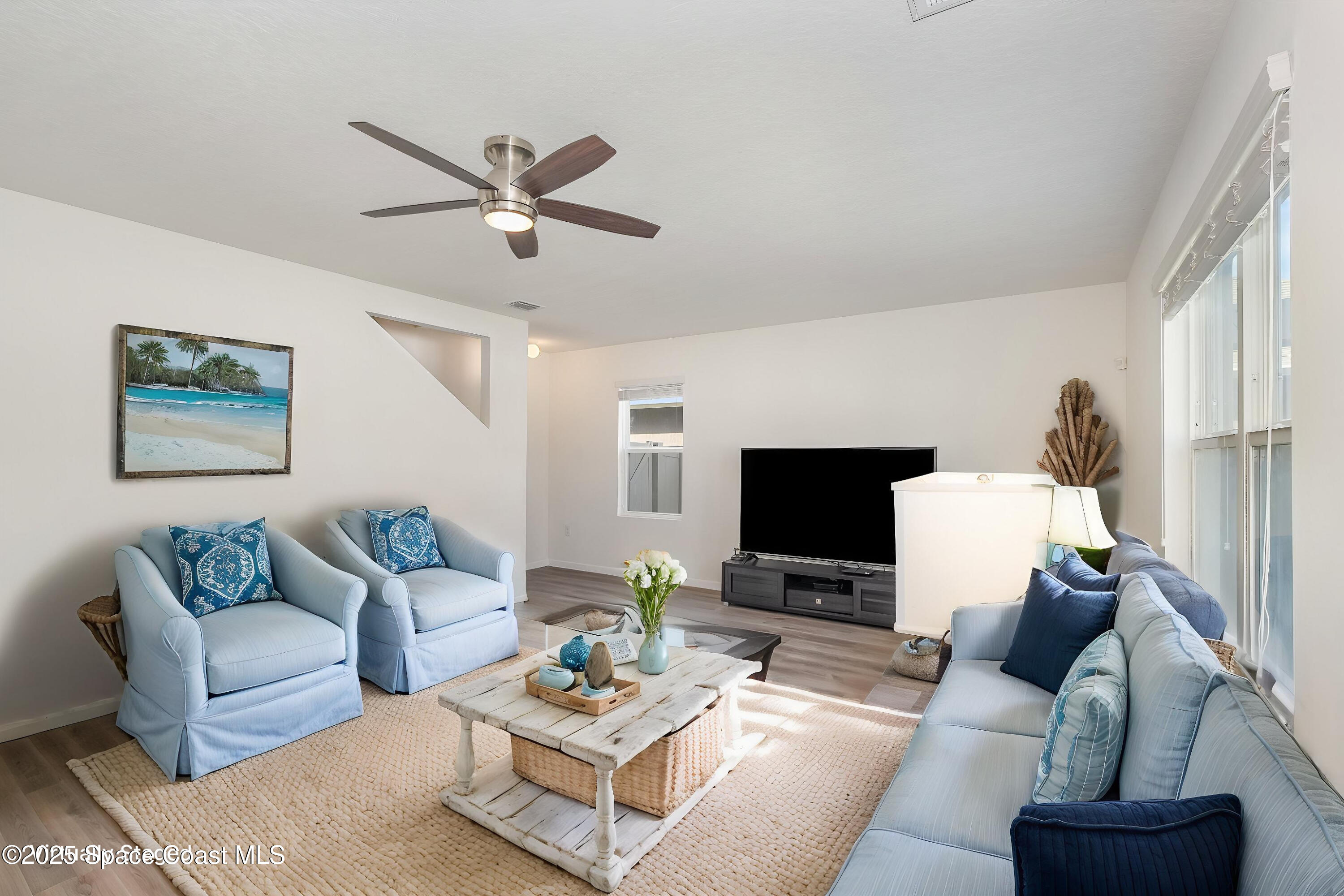 1085 Newton Circle Rockledge, FL 32955 - Photo 14 of 34 a living room with furniture a rug and a flat screen tv