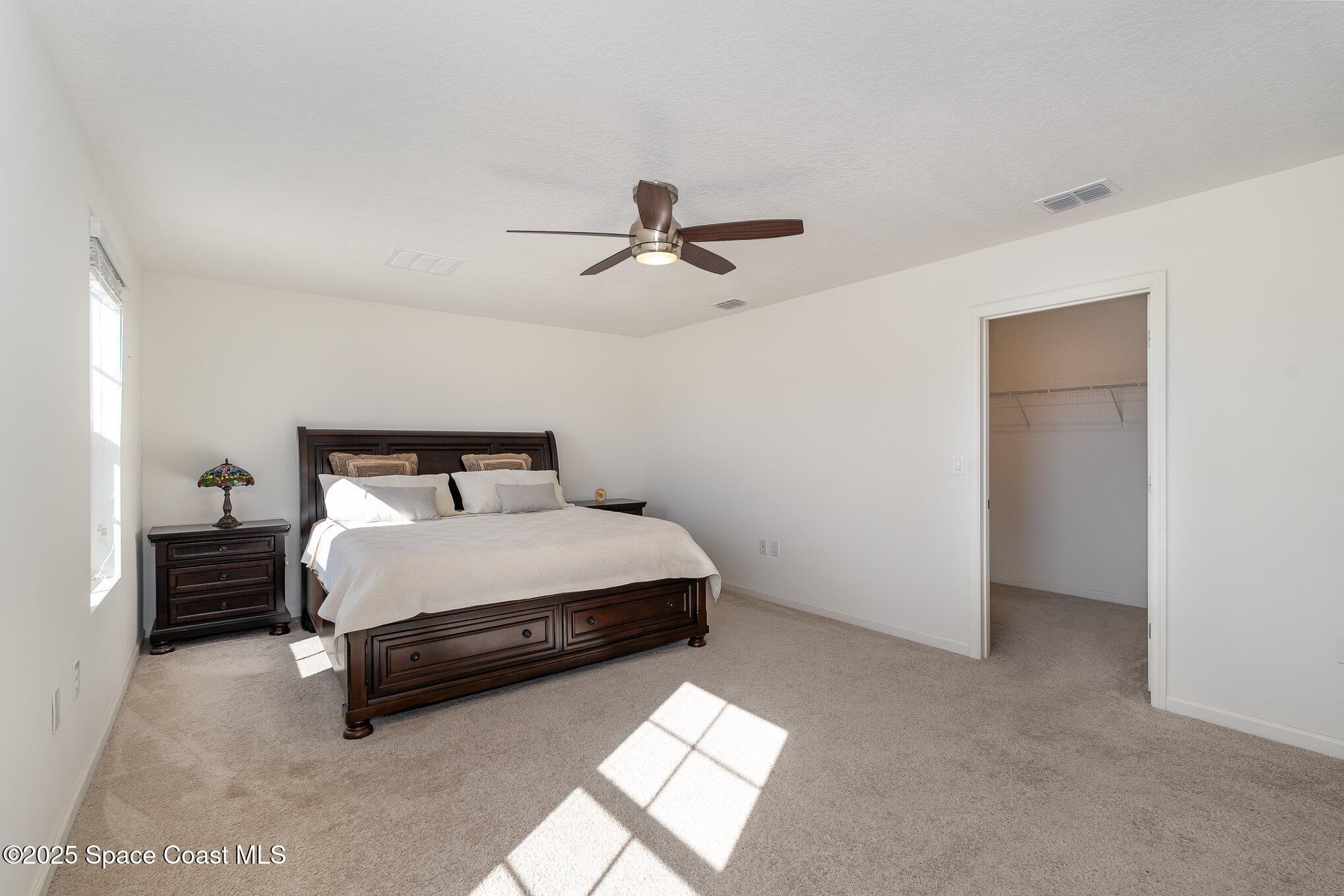 1085 Newton Circle Rockledge, FL 32955 - Photo 18 of 34 a bedroom with a bed and a ceiling fan