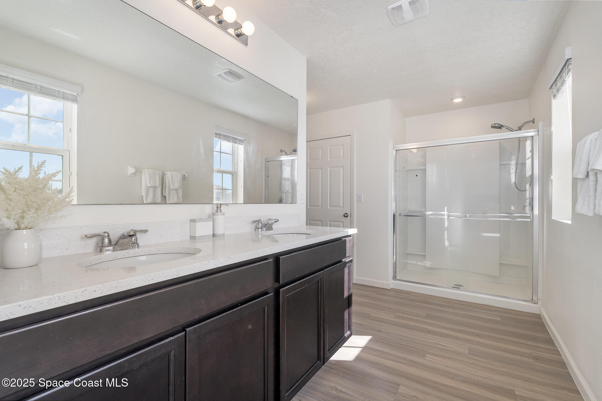 1085 Newton Circle Rockledge, FL 32955 - Photo 20 of 34 a bathroom with a double vanity sink mirror and shower