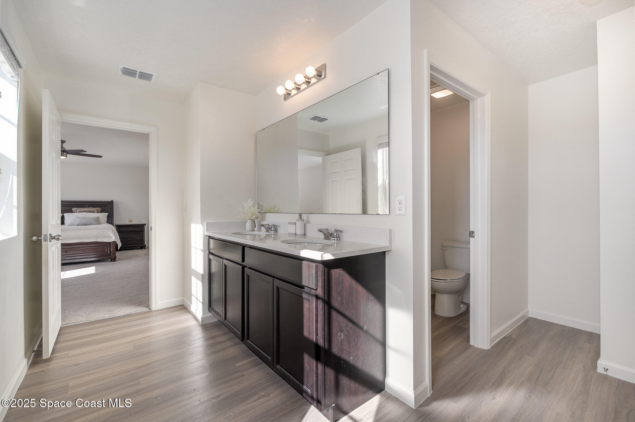 1085 Newton Circle Rockledge, FL 32955 - Photo 22 of 34 a en suite bathroom with a sink double vanity and a mirror