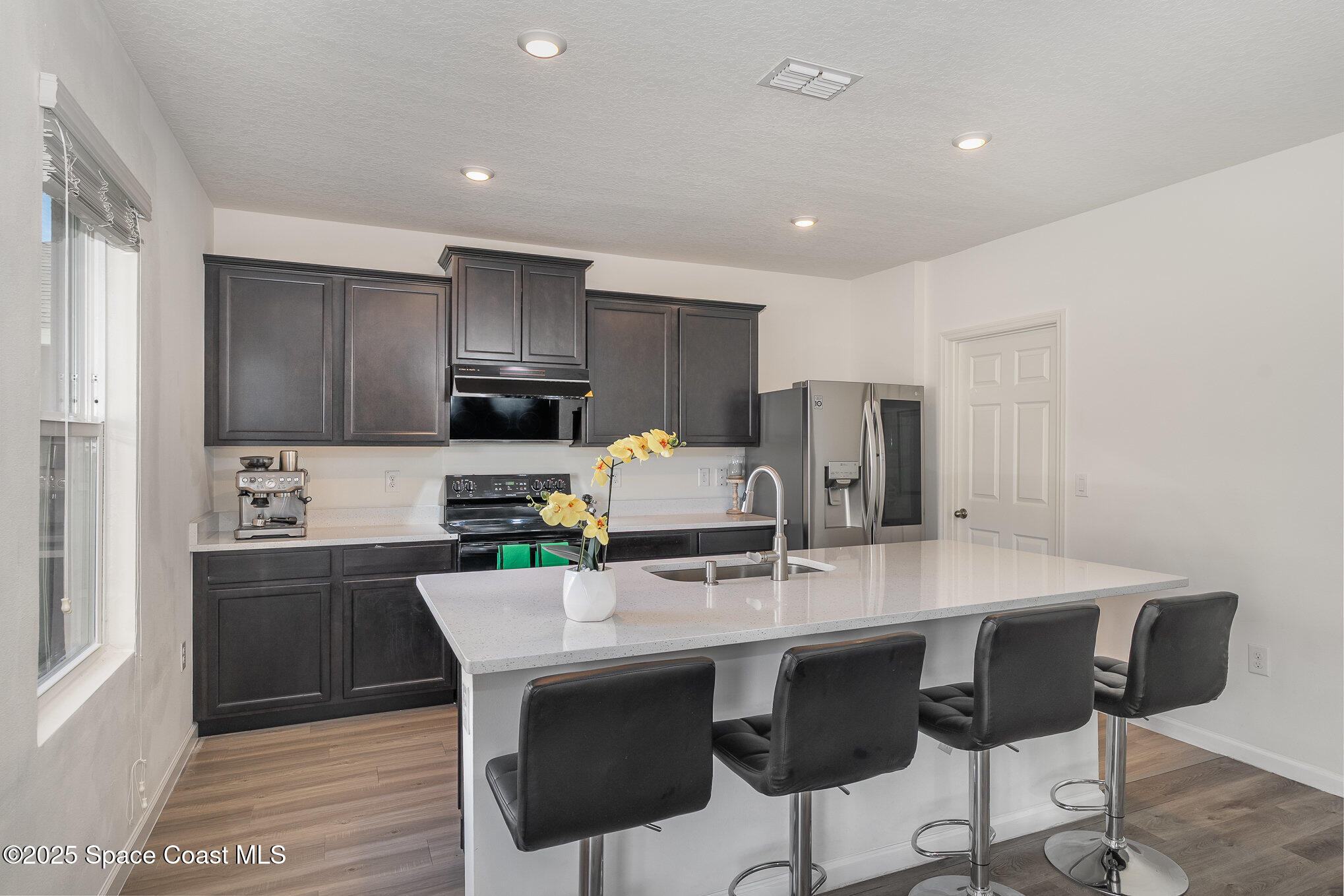 1085 Newton Circle Rockledge, FL 32955 - Photo 5 of 34 a kitchen with granite countertop a dining table and chairs