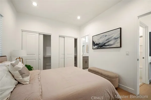 a bedroom with a bed and a painting on the wall