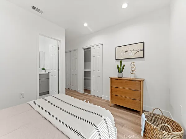 a bedroom with a bed and a potted plant