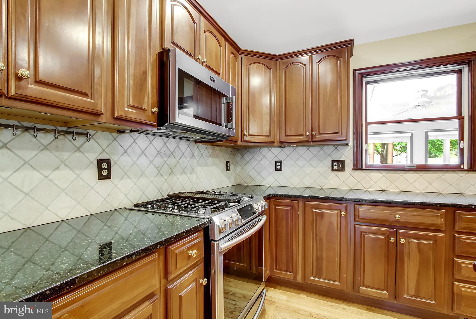 8642 Winding Way Perry Hall, MD 21128 - Photo 13 of 45 Granite countertops and ceramic tile backsplash