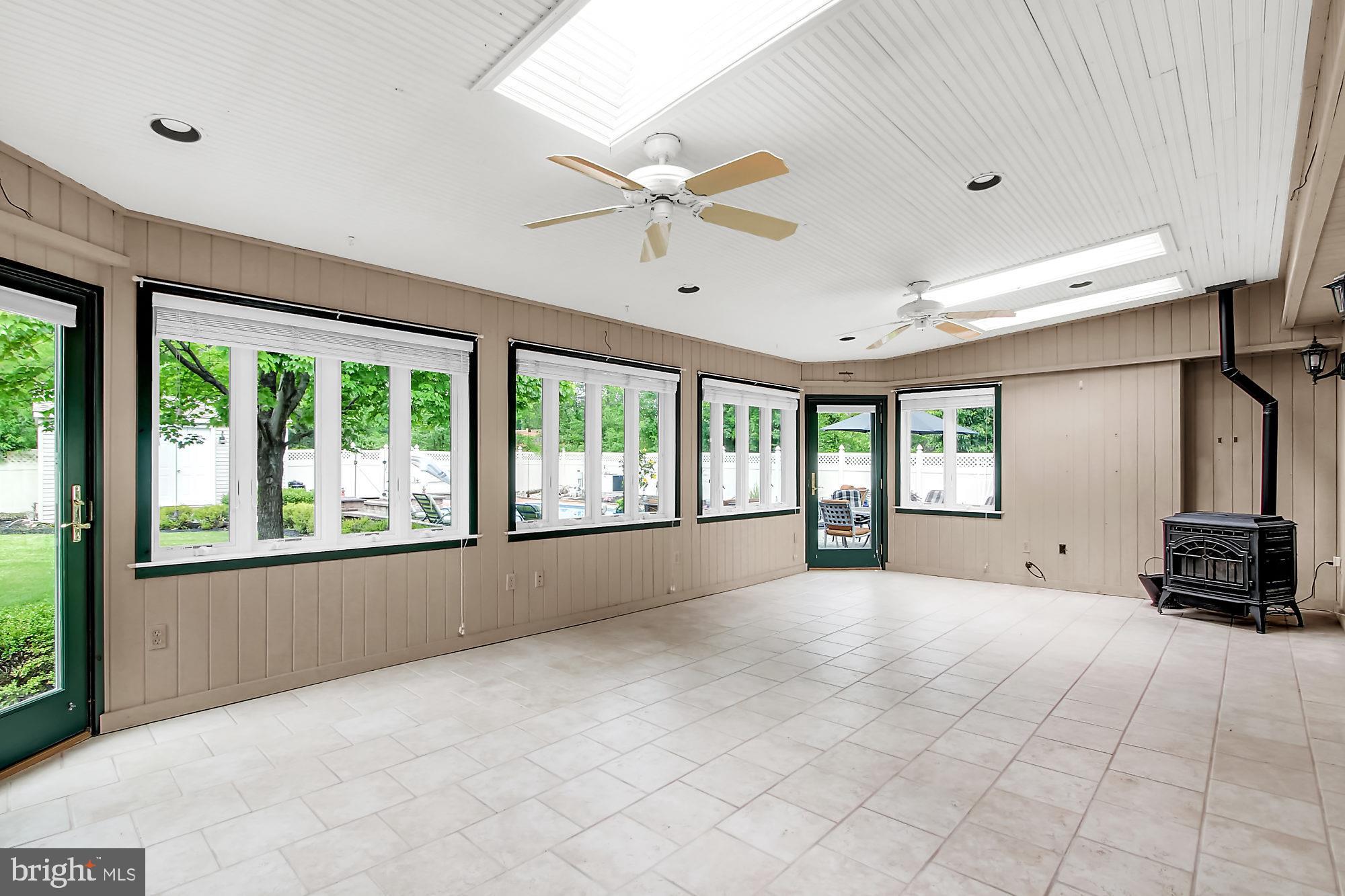 8642 Winding Way Perry Hall, MD 21128 - Photo 27 of 45 Main level sunroom features pellet stove
