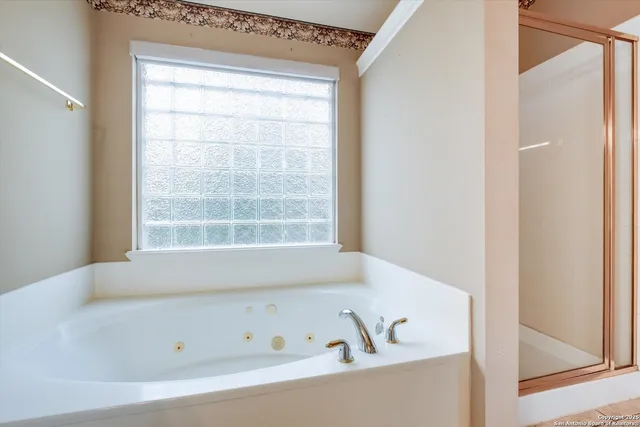 a bathroom with bathtub and window