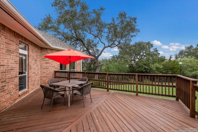 a view of balcony with wooden floor and outdoor seating