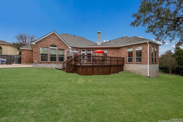 a view of a house with backyard and porch