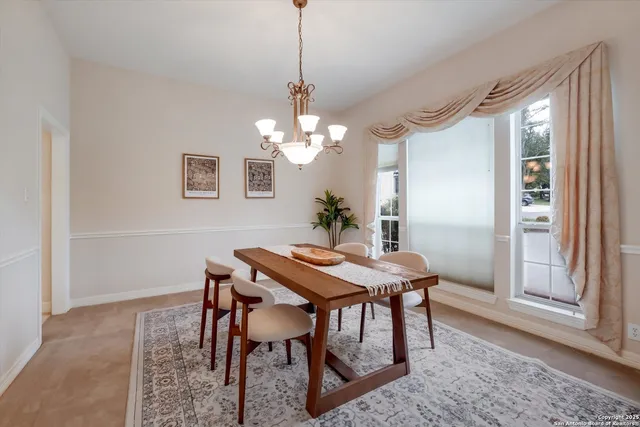 a view of a dining room with furniture and window