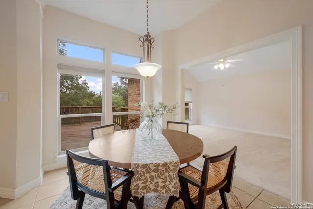 a dining room with furniture a chandelier and window