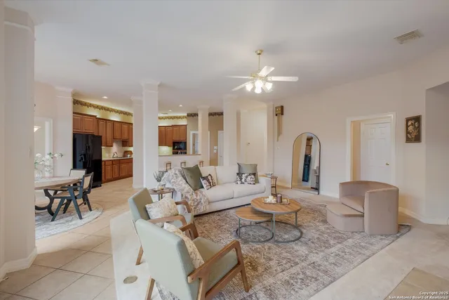 a living room with furniture a table and chairs