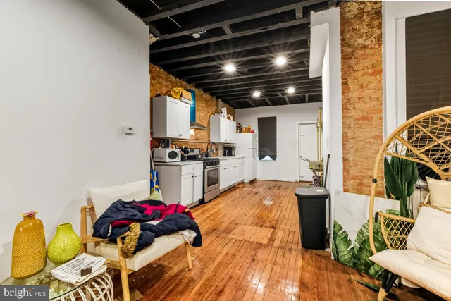 a kitchen with stainless steel appliances kitchen island granite countertop a stove and white cabinets