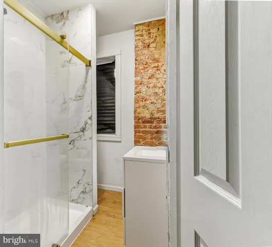 a bathroom with a shower and a sink