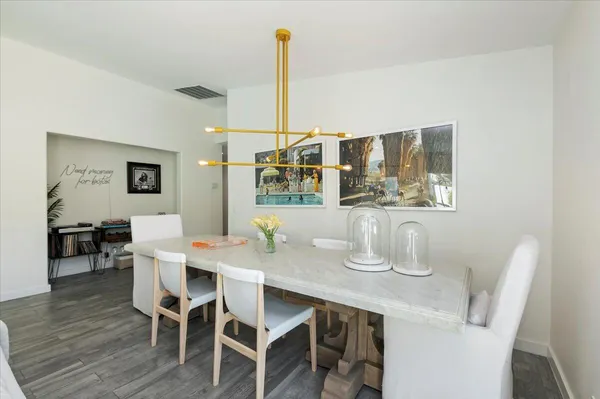 a dining room with furniture and wooden floor
