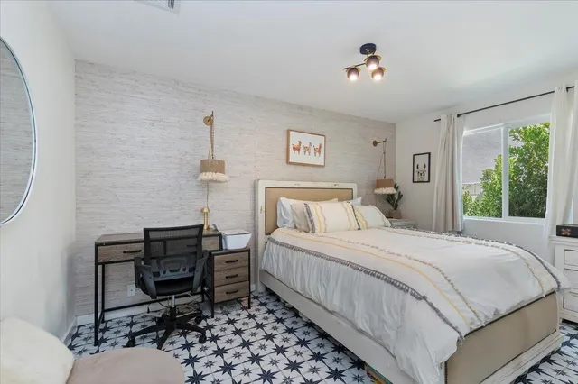 a bedroom with a bed and a table in it