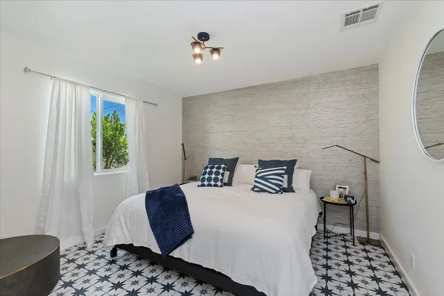 a bedroom with a bed and a window