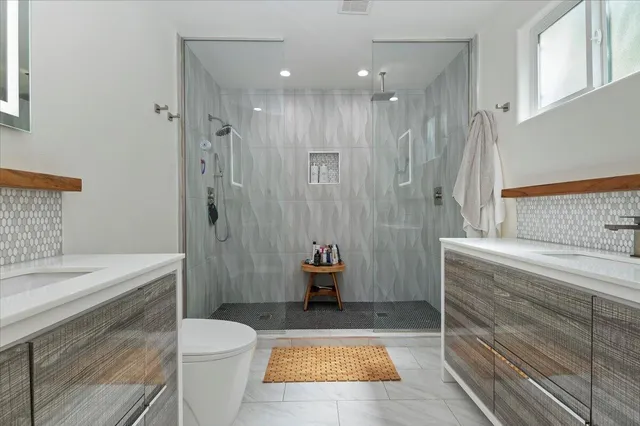 a bathroom with a sink a toilet and shower