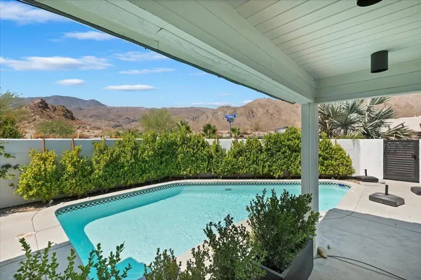 a view of a swimming pool with a patio