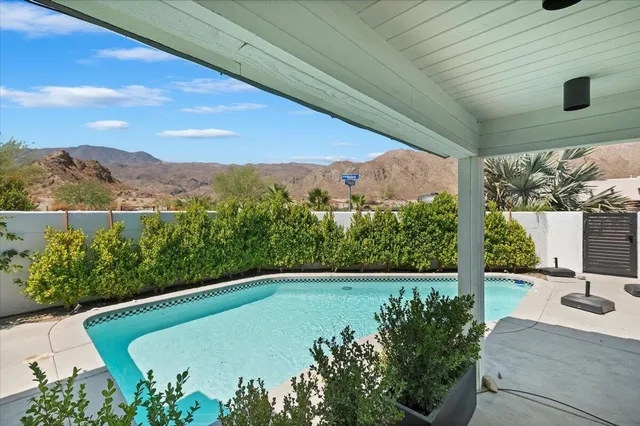 a view of a swimming pool with a patio