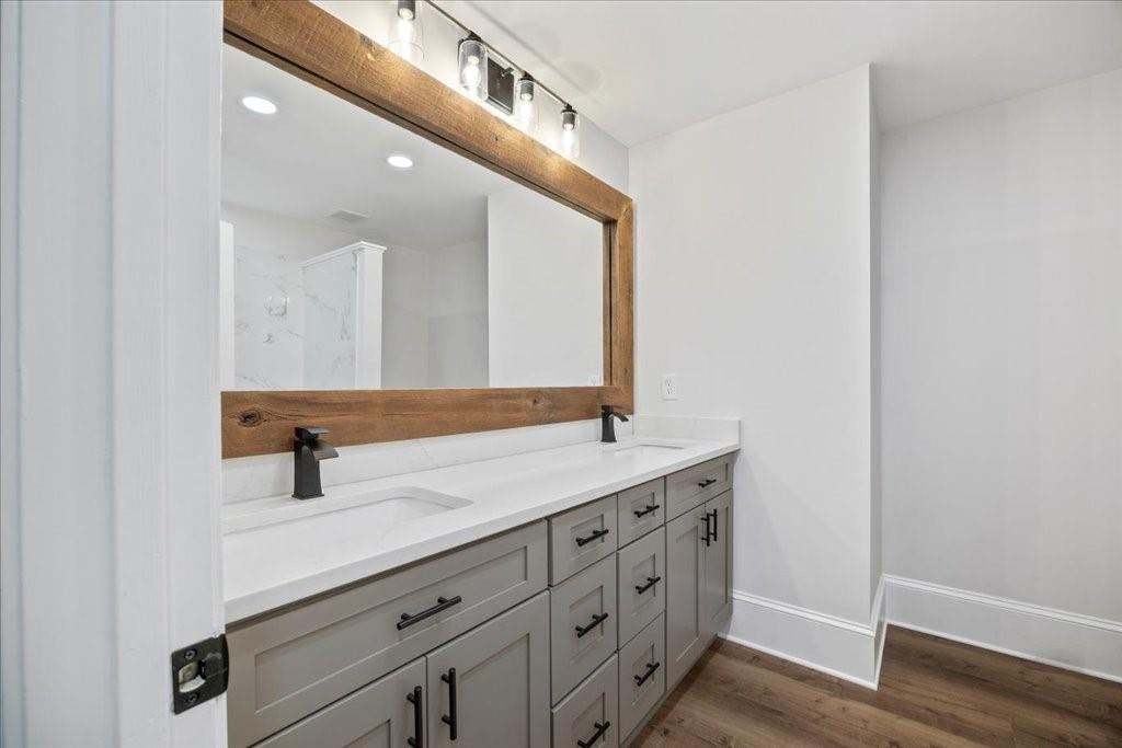 2400 Nebo Road Douglasville, GA 30134 - Photo 16 of 62 a bathroom with a double vanity sink and mirror