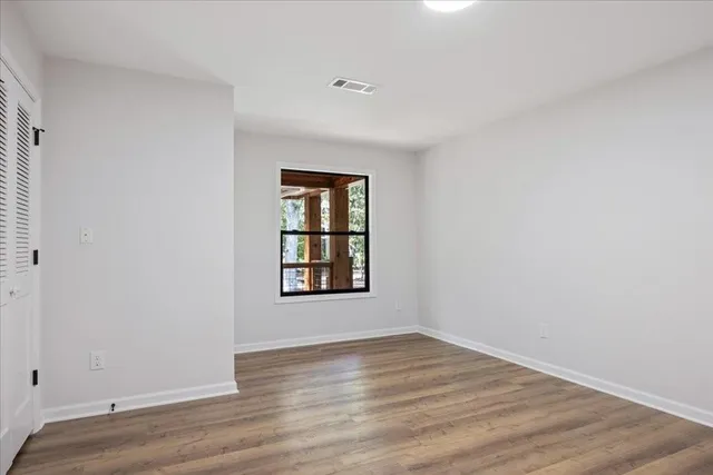 a view of room with wooden floor