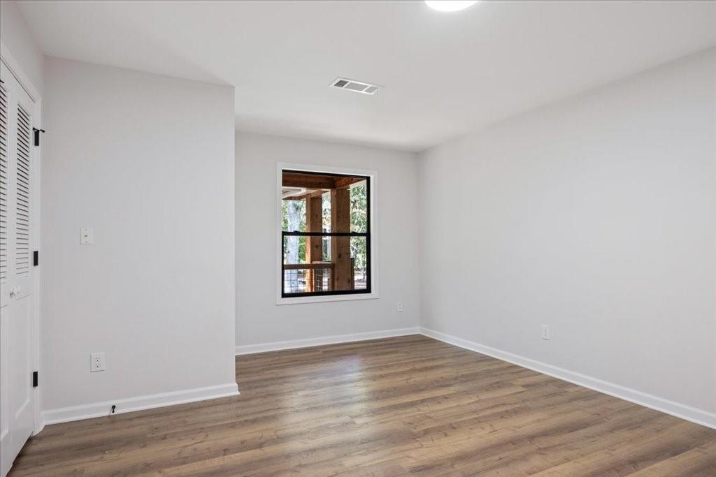 2400 Nebo Road Douglasville, GA 30134 - Photo 18 of 62 an empty room with wooden floor and windows