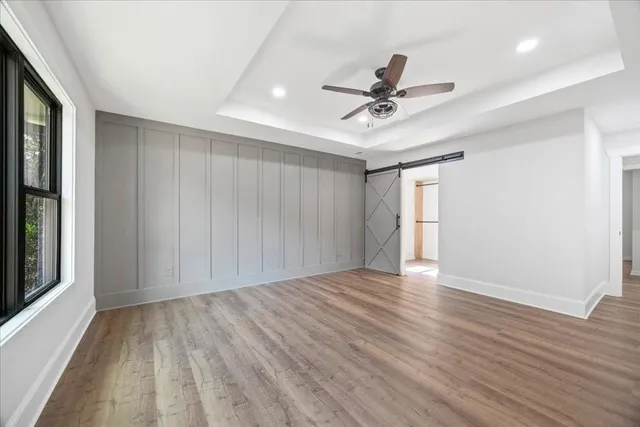 a view of empty room with wooden floor