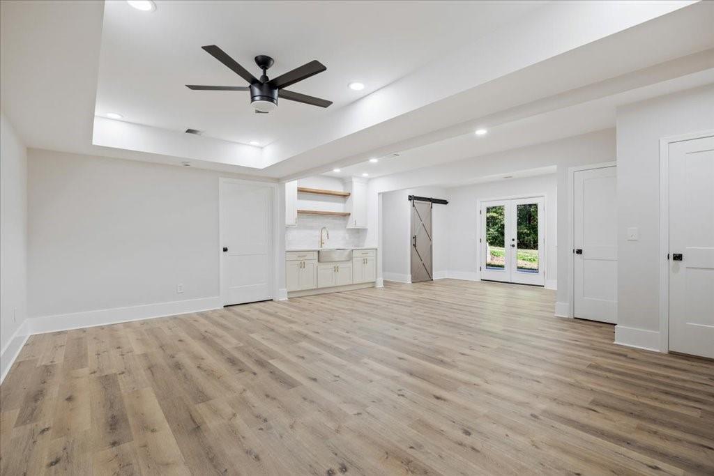 2400 Nebo Road Douglasville, GA 30134 - Photo 29 of 62 a view of a livingroom with a ceiling fan & wooden floor