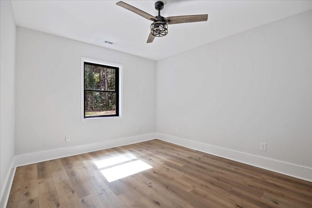 2400 Nebo Road Douglasville, GA 30134 - Photo 34 of 62 an empty room with a window and a ceiling fan
