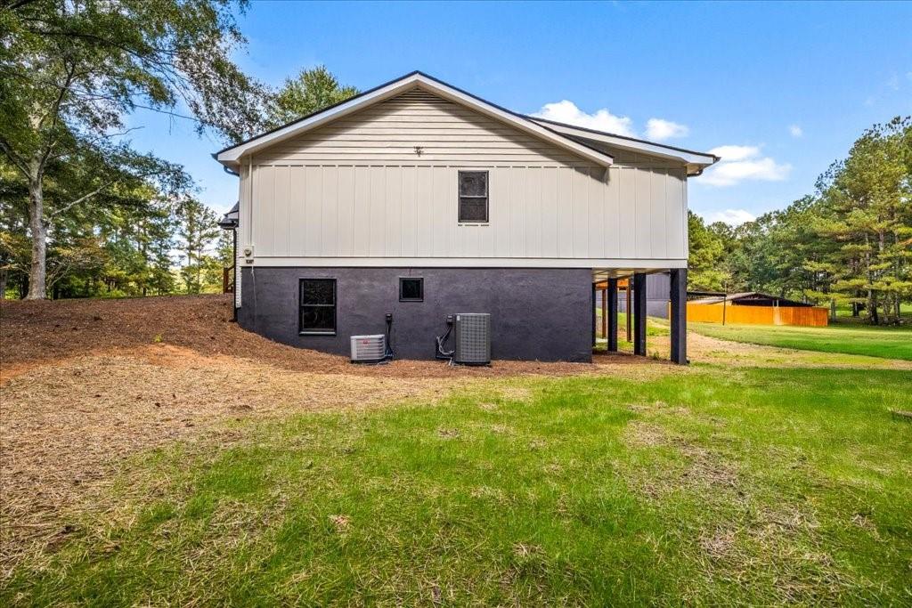 2400 Nebo Road Douglasville, GA 30134 - Photo 46 of 62 a front view of house with yard and trees in the background