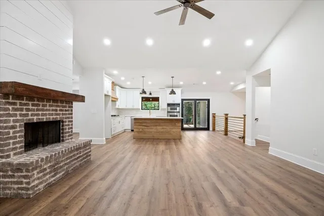 a large kitchen with stainless steel appliances granite countertop a stove a sink and a refrigerator