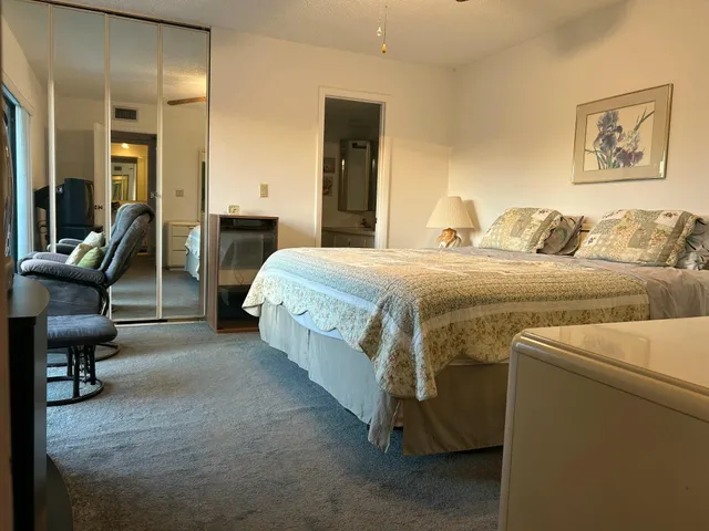 a bedroom with a bed and a chair