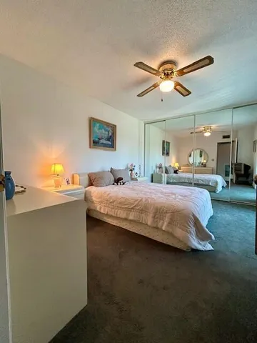 a bedroom with a bed and ceiling fan