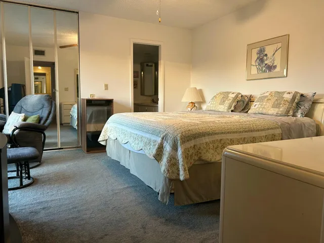 a spacious bedroom with a bed and furniture
