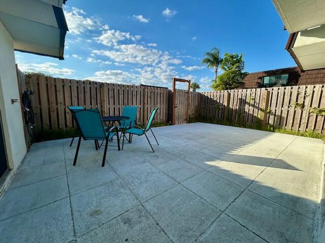 6166 Southeast Riverboat Drive, Unit 926 Stuart, FL 34997 - Photo 4 of 30 a view of a chairs and table in the backyard
