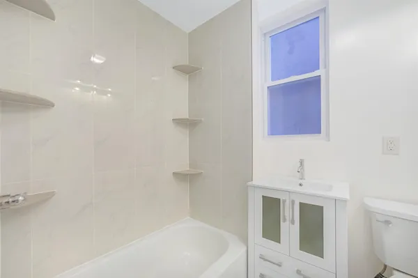 a bathroom with a bathtub sink and toilet