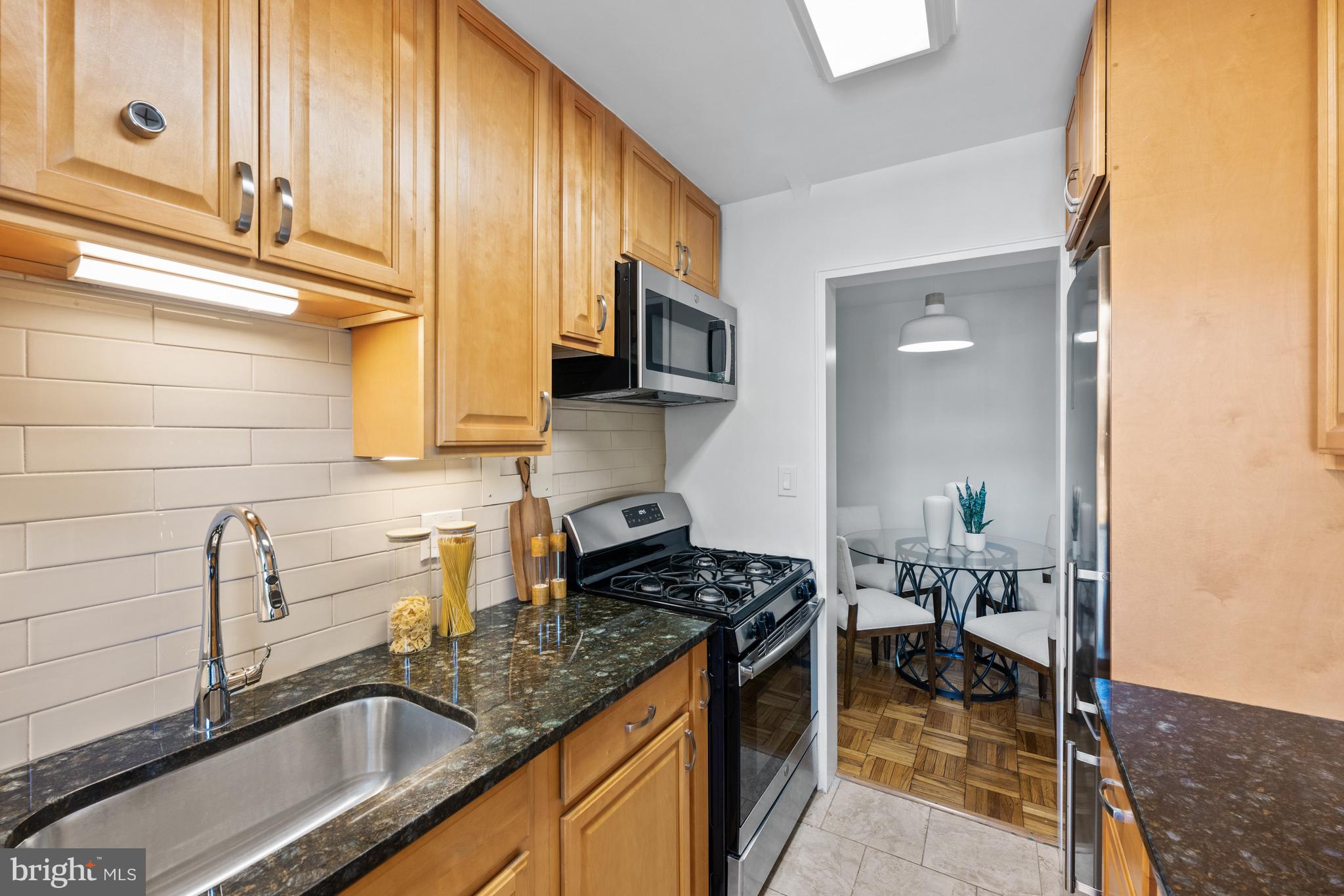 3901 Tunlaw Road Northwest, Unit 606 Washington, DC 20007 - Photo 13 of 37 Tile Backsplash and Brand New Microwave