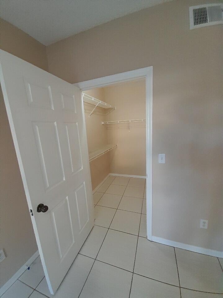 10336 Fox Trail Road South, Unit 1306 Royal Palm Beach, FL 33411 - Photo 7 of 10 a bathroom with a glass shower door