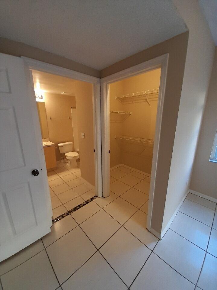 10336 Fox Trail Road South, Unit 1306 Royal Palm Beach, FL 33411 - Photo 8 of 10 a bathroom with a shower and a toilet