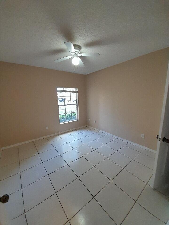 10336 Fox Trail Road South, Unit 1306 Royal Palm Beach, FL 33411 - Photo 9 of 10 a view of an empty room with a window