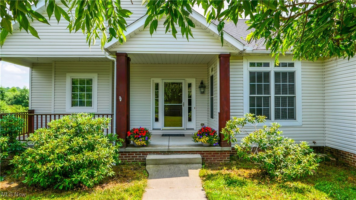 4840 Wayne Road Mantua, OH 44255 - Photo 2 of 42 Charming entrance to the home featuring a covered porch