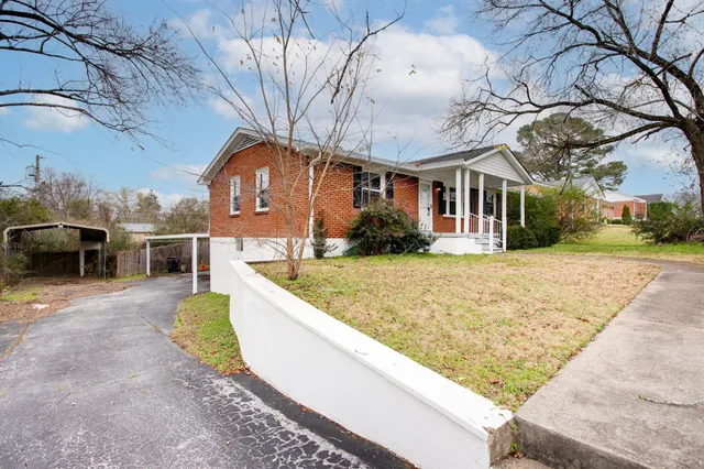 a view of a white house with a yard