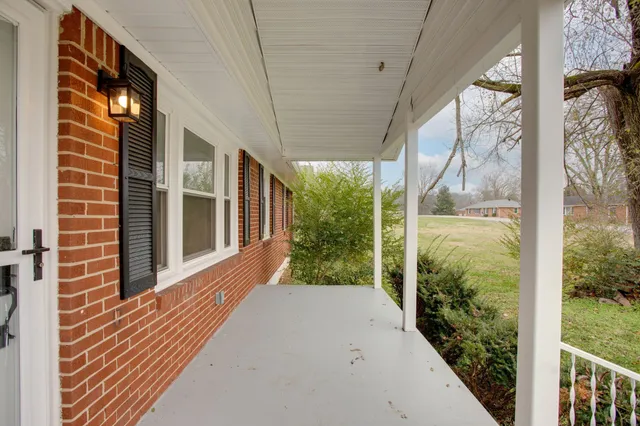 a view of a house with backyard and porch
