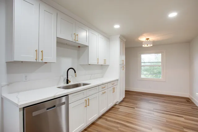 a kitchen with a sink cabinets and window