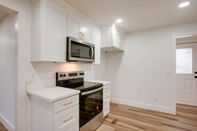 a kitchen with a stove and a microwave