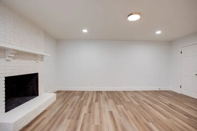 a view of room with hardwood floor and fireplace